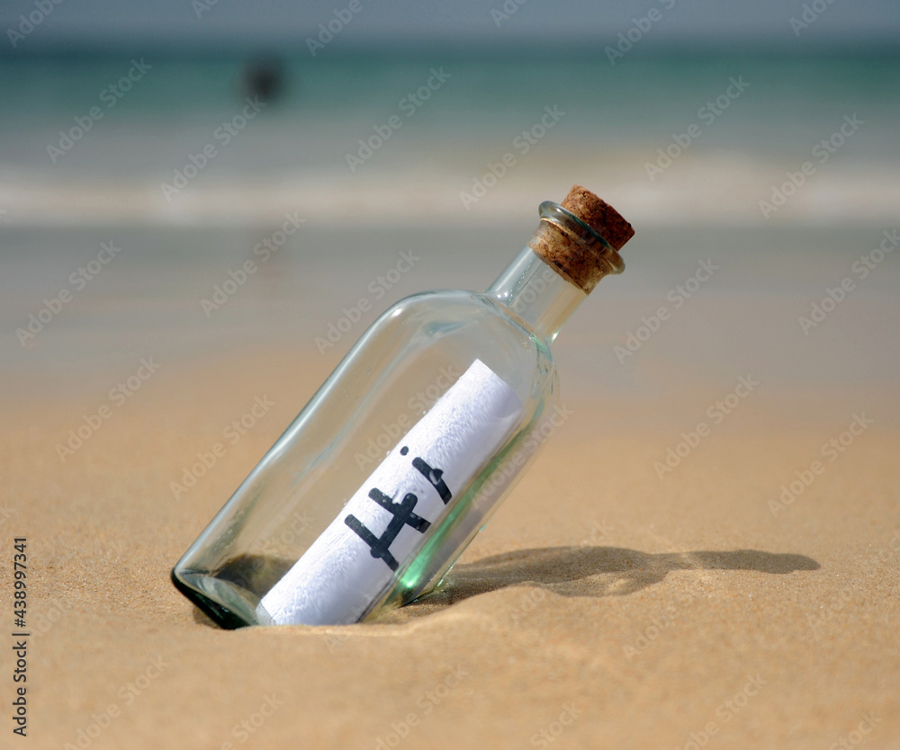 Hi! Bottle with greetings on beach. Funny holidays Hi! Bottle with greetings on beach. Funny holidays