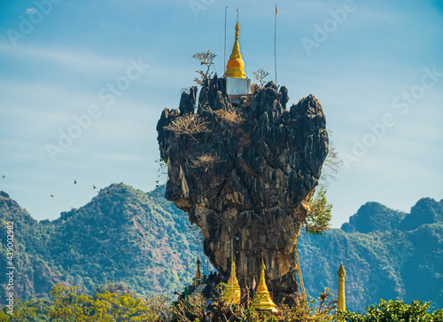 Amazing Buddhist Kyauk Kalap Pagoda under blue sky. Hpa-An, Myanmar (Burma) photo