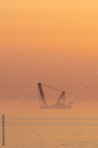 
A wind turbine installation barge off the Dutch coast, building an offshore wind park for wind energy
