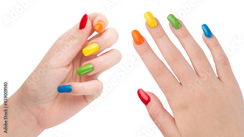 Rainbow colors manicure. Colorful nails. Woman hands after nail salon. Glossy nail polish. Gel or acrylic fake or false nails. Art nail design on fingers. Gay or LGBT pride. White isolated background.