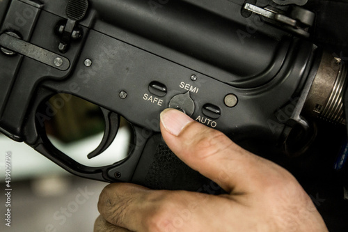 Valokuva Finger selecting Rifle gun selective switch on safe mode position