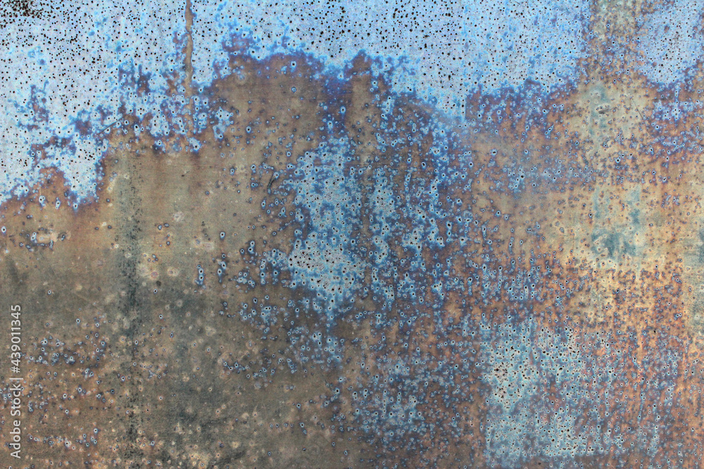 Metal old rusty defective wall with blue peeling paint for background