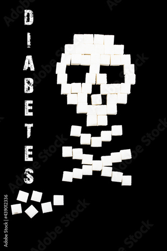 Deadly sugar addiction suggested by spilled white sugar crystals forming a skull. Diabetes mellitus concept photo