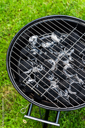 Charcoal BBQ or Grill on Grass or Lawn in Garden