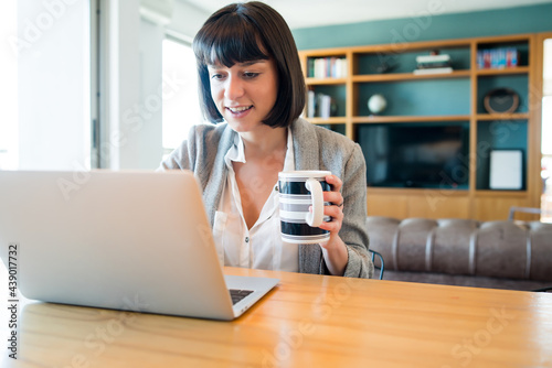 Woman working with laptop from home.