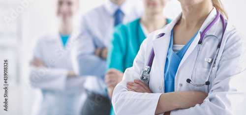 Attractive female doctor in front of medical group