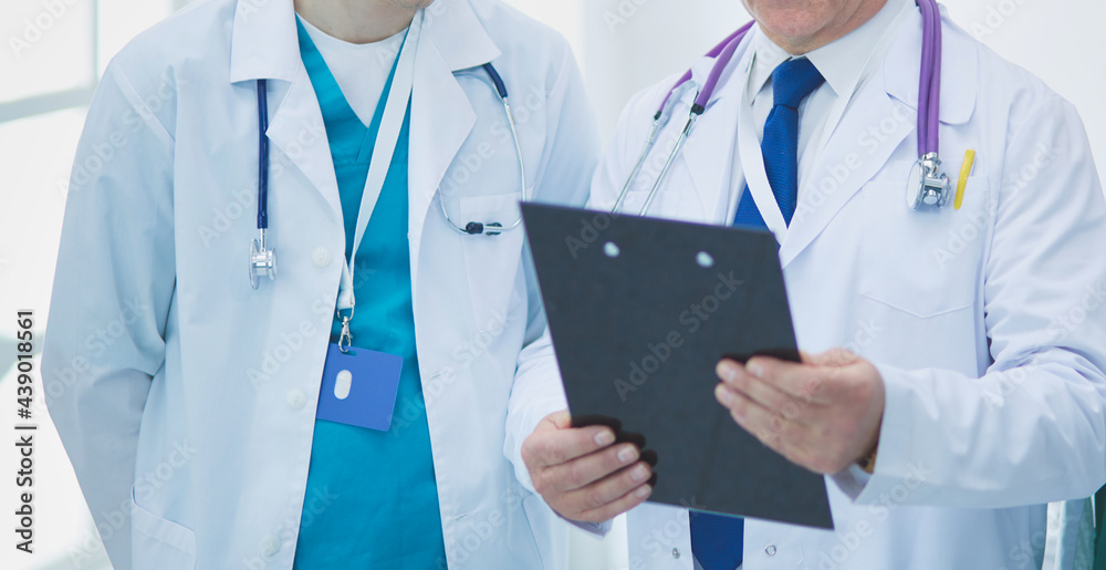 Successful medical team. Confident doctors team standing together and smiling Successful medical team. Confident doctors team standing together and smiling