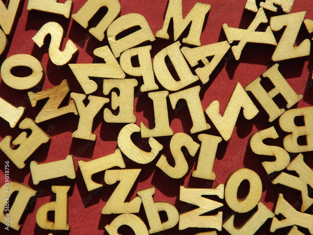 wooden letters of the English alphabet on burgundy suede as a background. High quality photo wooden letters of the English alphabet on burgundy suede as a background. High quality photo