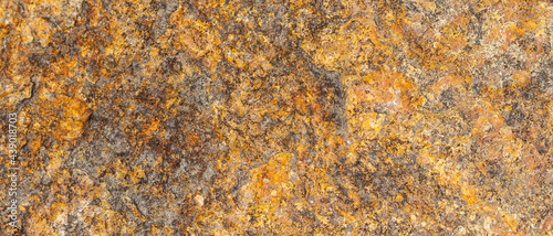 Background of granite. Texture of brown granite stone. Weathered stone surface. Copy space