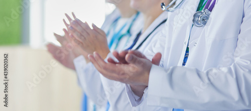 Medical team clapping their hands during a meeting