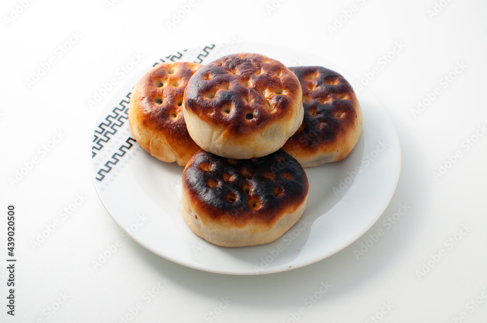 Manju - a traditional japanese food - in a white plate on a white table or background Manju - a traditional japanese food - in a white plate on a white table or background