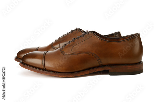 Men's brown oxford fashion shoes isolated on a white background. © CSLWP