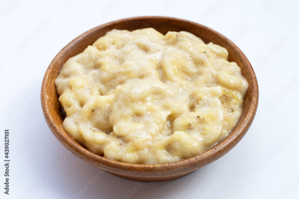Mashed Bananas in wooden bowl on white background. Mashed Bananas in wooden bowl on white background.