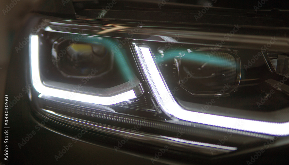 Headlight of a modern car close up. Modern technology concept. Headlight of a modern car close up. Modern technology concept.