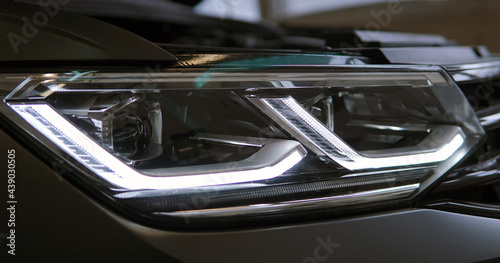 Headlight of a modern car close up. Modern technology concept. Selected focus.	