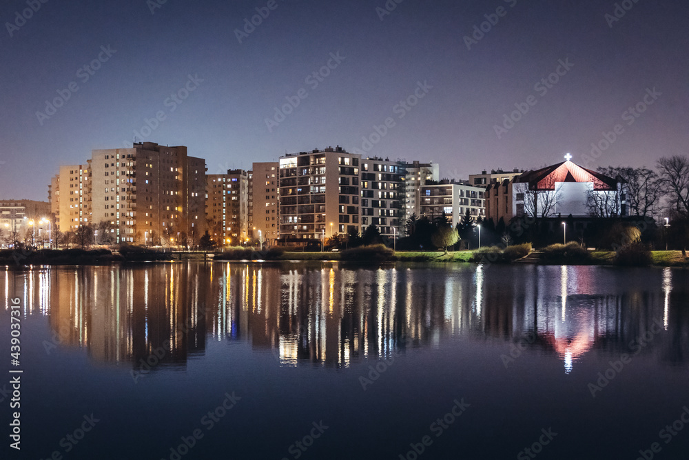Apartment buildings and church over lake Balaton in Goclaw neighborhood of Warsaw, capital of Poland