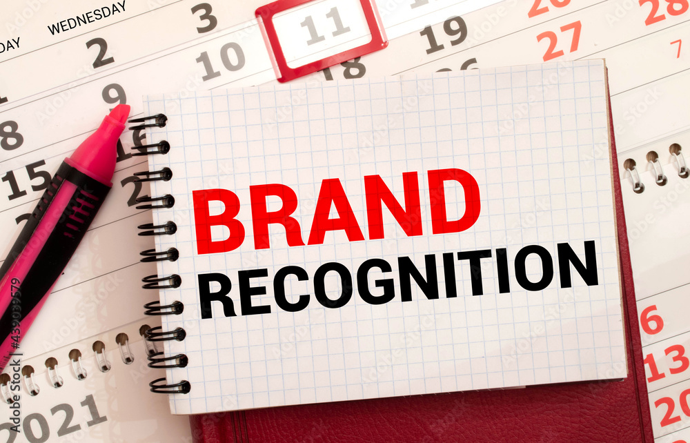 Brand Recognition inscription on a sheet and 4 on the background of financial reporting Brand Recognition inscription on a sheet and 4 on the background of financial reporting