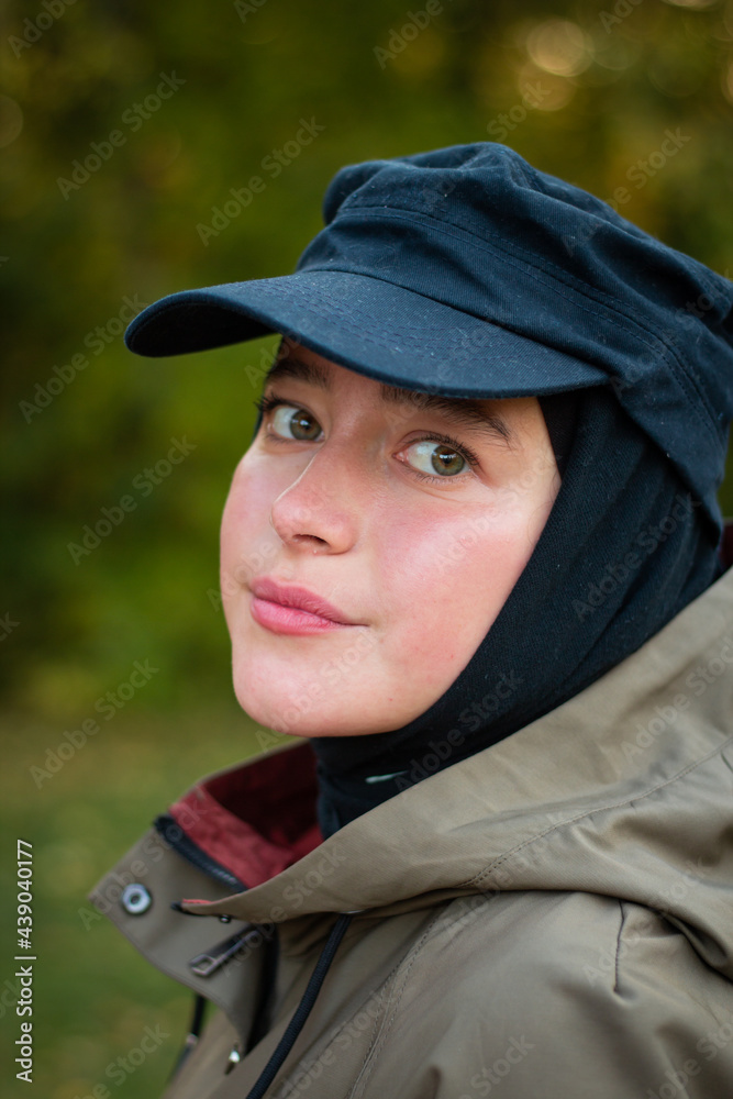 Fashionable Muslim woman in a black cap. Fashion industry. Face. Close up