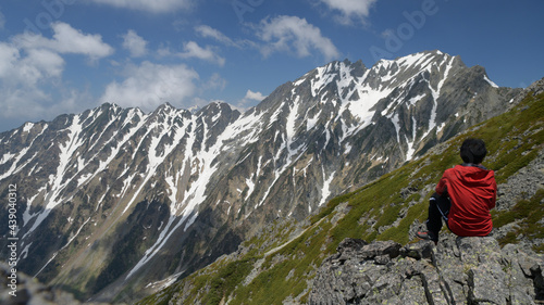 hiker looking at hotaka mountains, japan alps