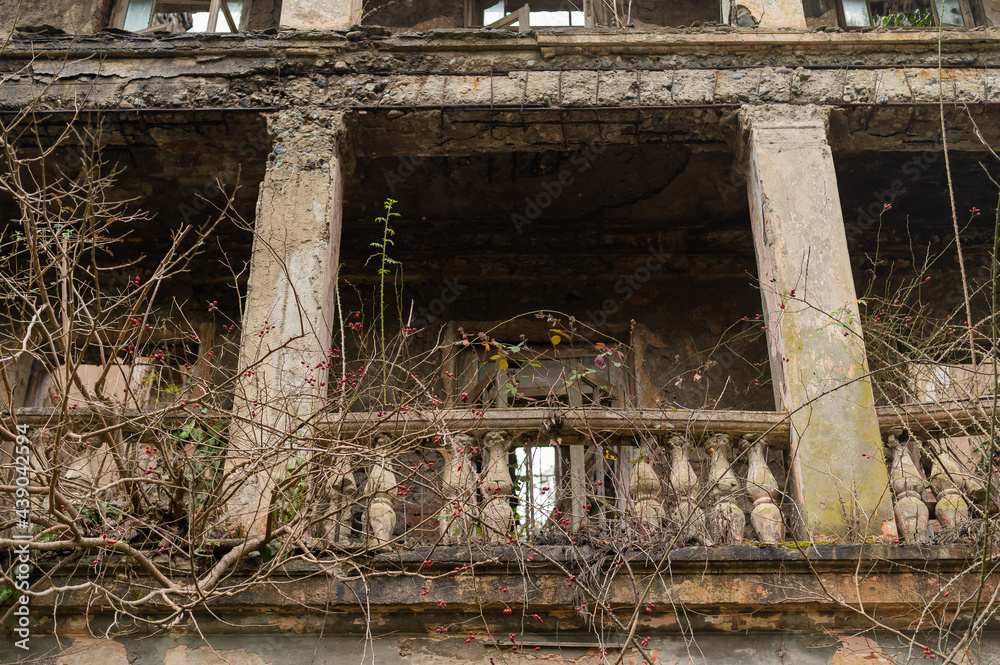 View of the facade of an abandoned ruined house in abkhazia.