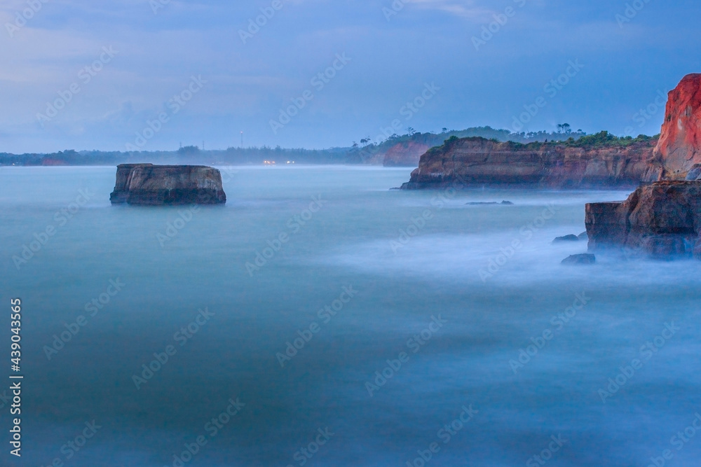 picture of cliff with blue water and golden beach in Indonesia,Bengkulu view from the top view from the top of the mountain. Travel paradise destination for adventure. with the long exposure technique