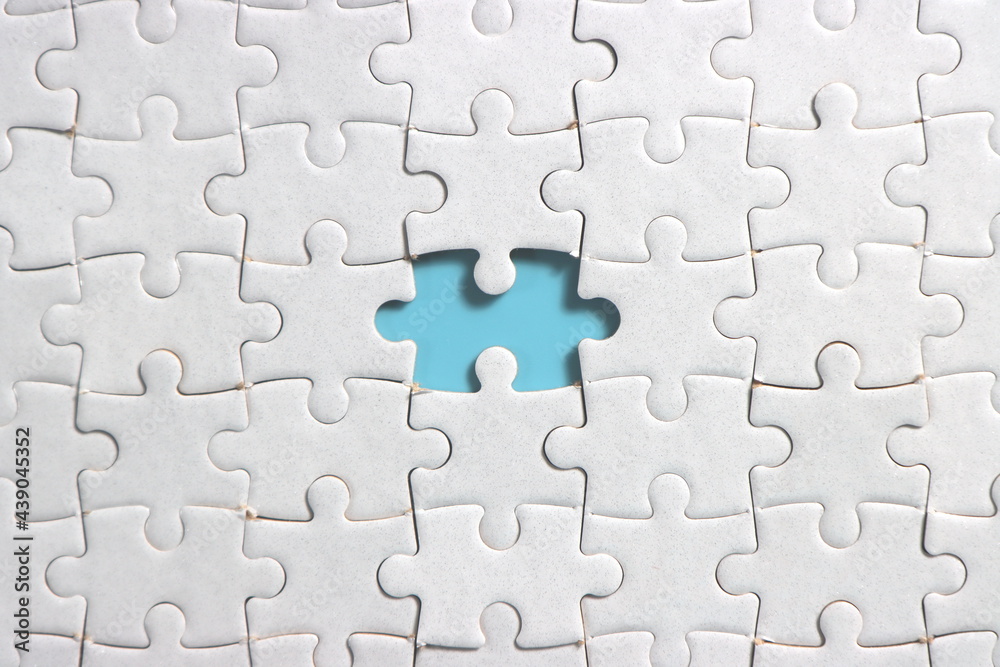 Fototapeta premium Jigsaw puzzle with missing piece. Missing puzzle pieces. Concept image of unfinished task. Completing final task, missing jigsaw puzzle pieces and business concept with a puzzle piece missing. blue