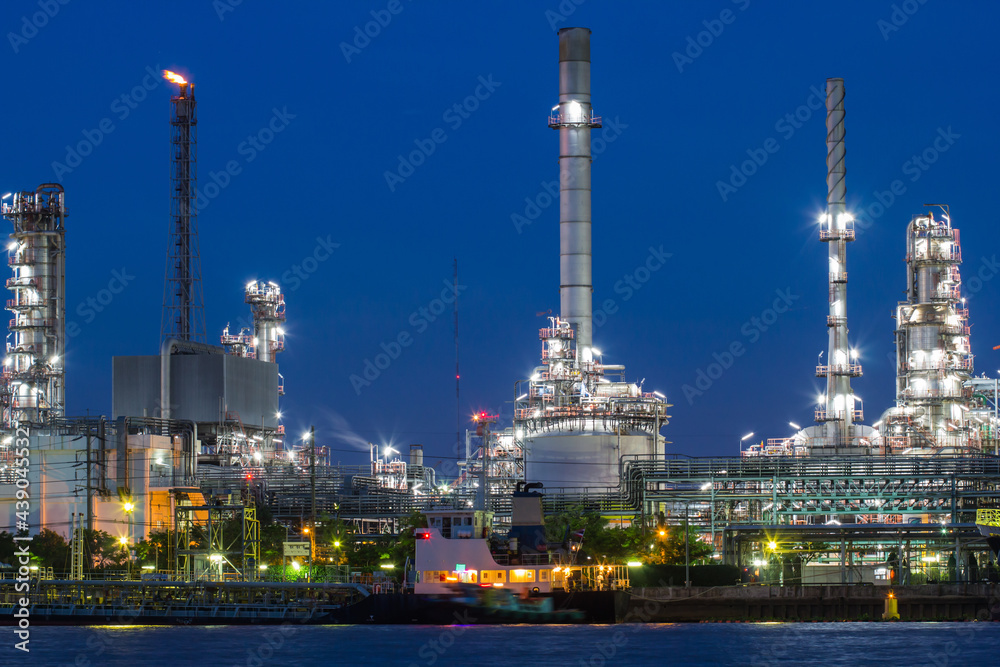 Oil refinery river side with boat supply tank Oil refinery river side with boat supply tank