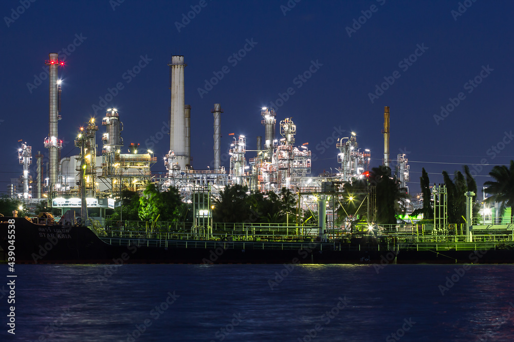 Oil refinery river side with boat supply tank