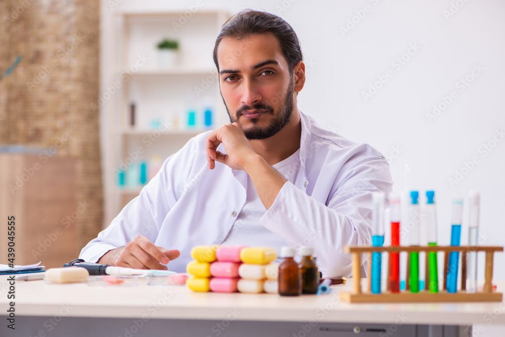 Young male chemist testing soap in the lab Young male chemist testing soap in the lab