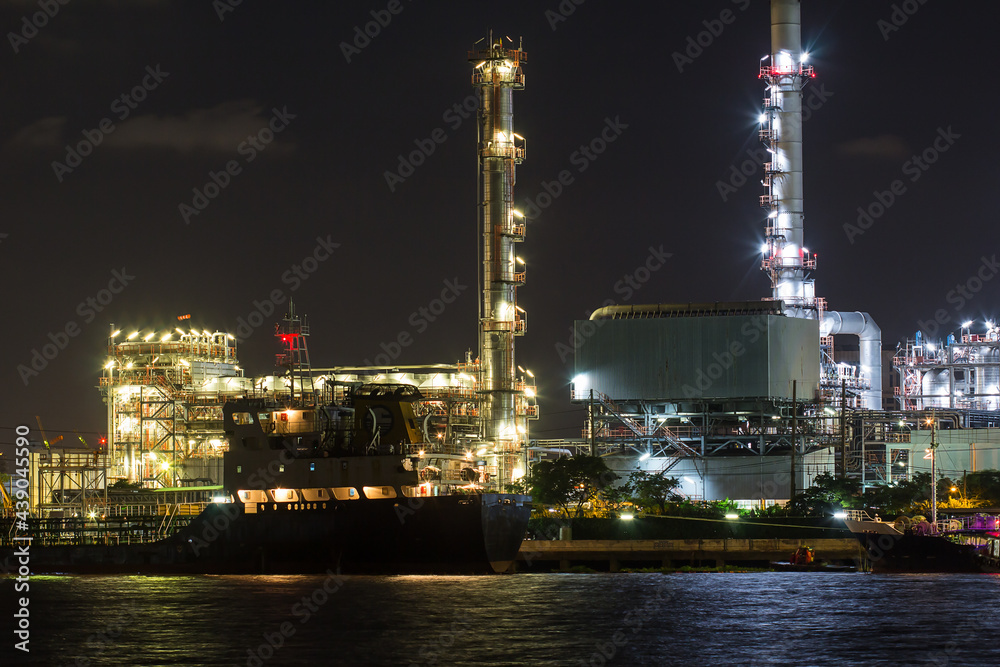 Oil refinery on water side front  at night