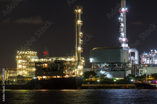 Oil refinery on water side front at night