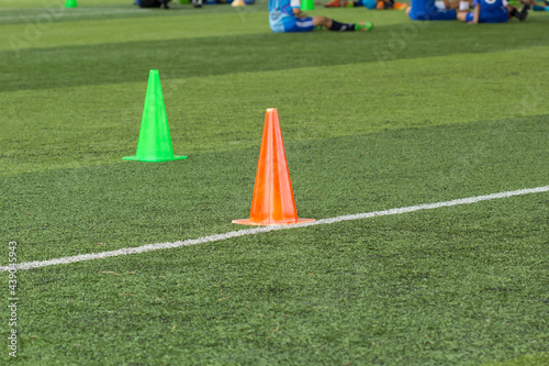  Soccer ball tactics on grass field with cone