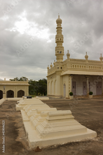 A magnificent picture of a few tombs and an Islam mosque minarets of  Muslim rulers against the cloudy sky in Karnataka state, in India. photo