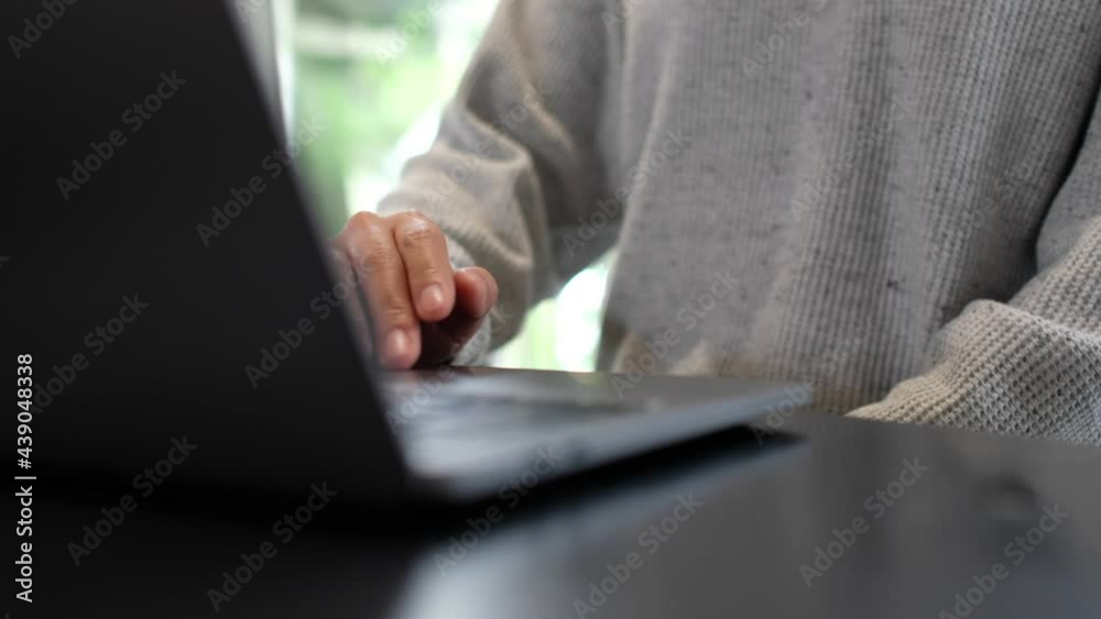 Closeup a woman working and touching on laptop computer touchpad on the table Closeup a woman working and touching on laptop computer touchpad on the table