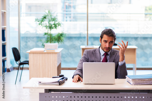 Young male employee working in the office