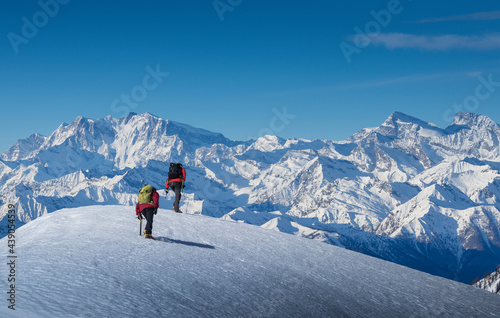France, Haute Savoie, Chamonix, Climbers ascending snowy slope in area of Mont Blanc photo