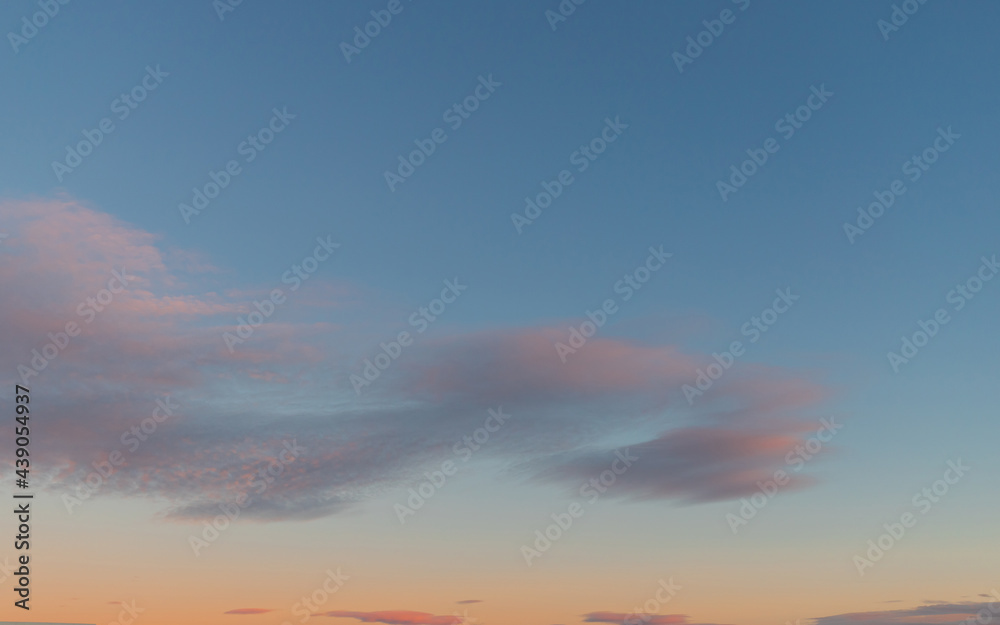 Pink clouds on blue-orange sky at sunset time. Pink clouds on blue-orange sky at sunset time.