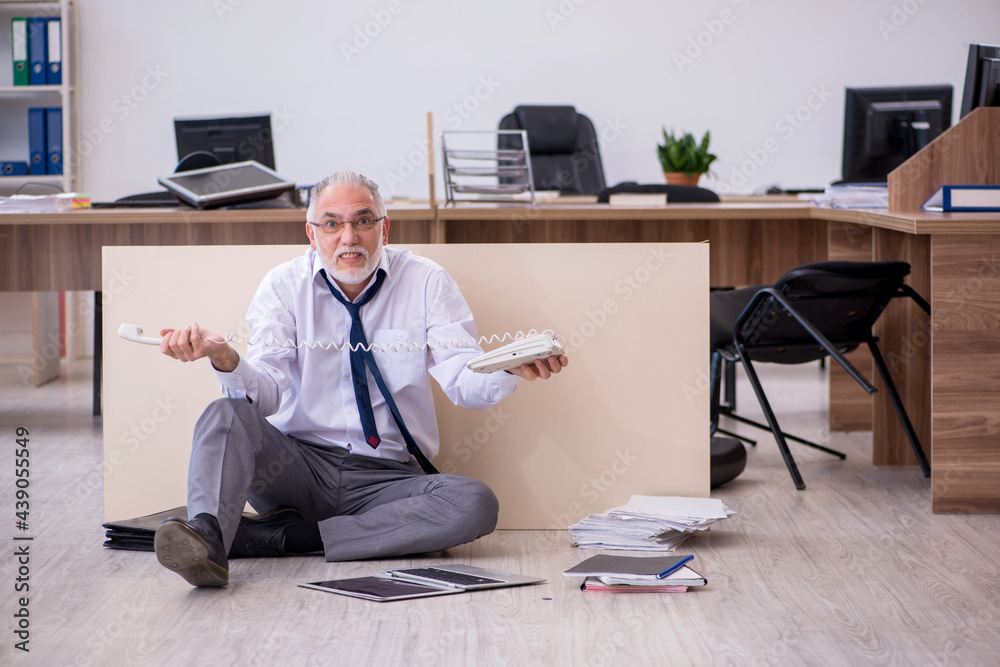 Old businessman employee in bankruptcy concept in the office Old businessman employee in bankruptcy concept in the office