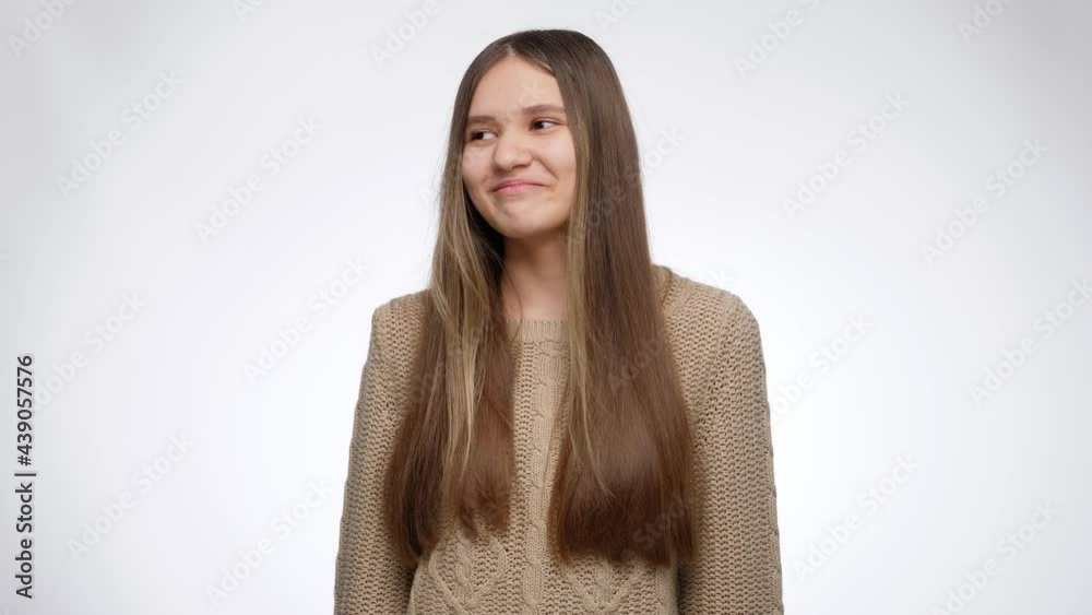 Funny portrait of smiling girl making faces and flirting over white studio background Funny portrait of smiling girl making faces and flirting over white studio background