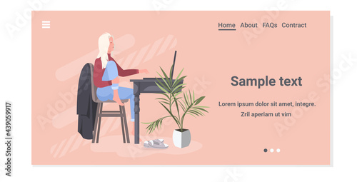 young woman freelancer sitting at workplace working on laptop coronavirus pandemic quarantine