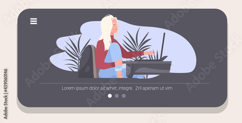 young woman freelancer sitting at workplace working on laptop coronavirus pandemic quarantine self isolation