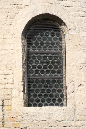 Close-up of window of old protestant roman church at the old town of Payerne at summertime. Photo taken June 11th, 2021, Payerne, Switzerland.