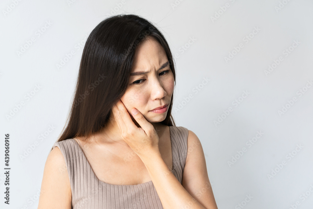 Portrait of woman feeling tooth pain. Closeup of sad girl suffering from teeth pain. Asian female feeling painful toothache on white background. Dental health and care, teeth problem. Copy space Portrait of woman feeling tooth pain. Closeup of sad girl suffering from teeth pain. Asian female feeling painful toothache on white background. Dental health and care, teeth problem. Copy space