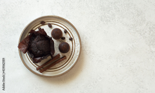 Chocolate muffin, candies and cinnamon sticks