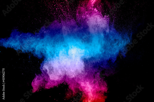 Pink blue dust particles splash on black background.Pink blue powder splash.