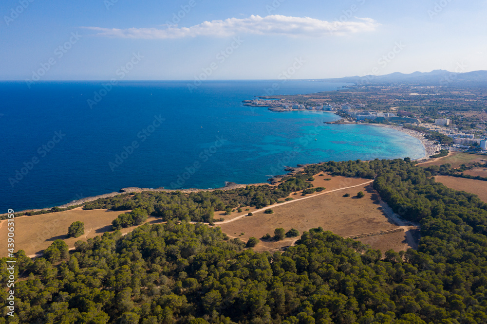 An aerial panoramic view on Sa Coma beach on Mallorca island in Spain at evening time