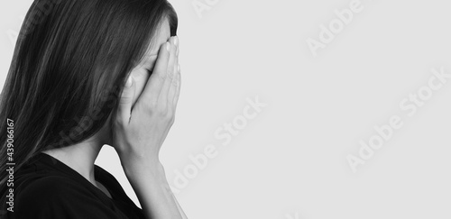 Slika na platnu The girl covers her face with her hands and cries
