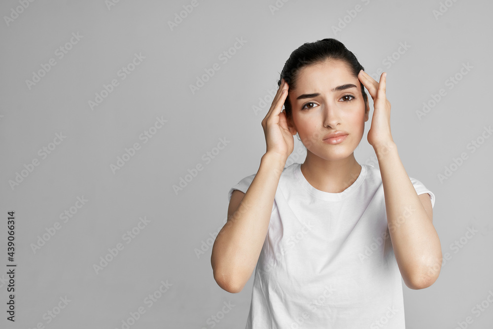 disgruntled woman holding her head migraine depression lifestyle light background disgruntled woman holding her head migraine depression lifestyle light background