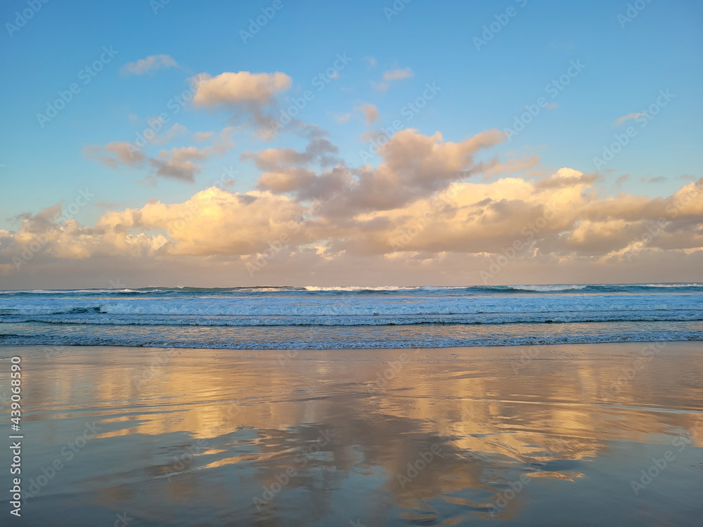 Beach sunset fluffy clouds