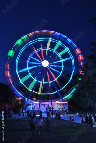 Fun fair at sunset and night big wheel
